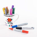 Decorative mug with colorful markers and Porcelain markers on a white background