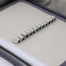 Close-up of a textured gray strap on a fabric surface