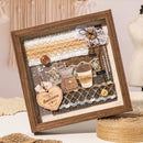 Decorative shadow box with coffee-themed elements and wooden frame.