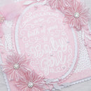 Pink baby shower card with white text and floral designs
