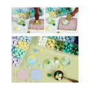 Colorful candy assortment with a focus on green and pastel shades, displayed in a box.