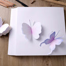 Butterfly drawings on a piece of paper with stationery items on a wooden surface