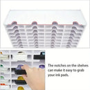 White ink pad organizer with notches for easy access, showing a hand grabbing an ink pad.