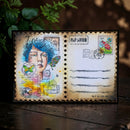 Decorative postcard with artistic design and stamps on a wooden surface