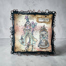 Decorative pillow with artistic design of a woman and clock, text 'The journey begins now', on a textured surface.