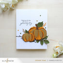 Greeting card with pumpkins and floral elements on a light background, featuring the brand 'Altenew'.