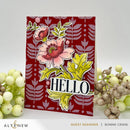 Card with floral design and 'HELLO' text on a red patterned background, surrounded by decorative elements.