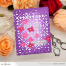 Purple card with floral design and 'Hope your wishes come true' text, surrounded by flowers and a keychain.