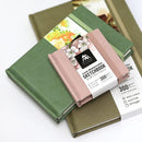 Set of watercolor sketchbooks with a pink one on top, featuring a brand label.