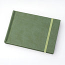 Green notebook with a strap on a white background