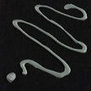 White silicone hooks on a black background