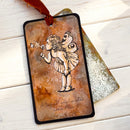 Decorative card with fairy illustration and text on a wooden surface
