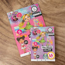 Two card making kits with colorful designs on a wooden surface