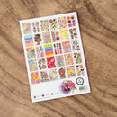 Sheet of colorful stickers on a wooden surface