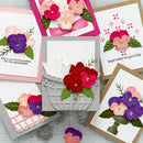 Collection of handmade cards with floral designs on a textured surface.