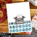 Greeting card with typewriter design and 'thank you' message on a wooden surface.