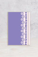 Notebook with floral and chevron pattern on a gray surface