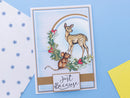 Greeting card with deer and mouse illustration on a blue background