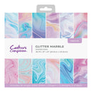 Packaging of Crafters Companion glitter marble paper pad with colorful swatch samples.