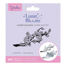 Packaging of 'Lunar Blooms' cherry blossom stamp and die set with a branch illustration on a light purple background.