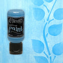 Bottle of Dylusions paint with a blue leafy background