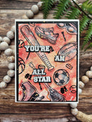 Card with sports-themed design and 'You're an All Star' text on a wooden surface with decorative elements.