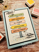 Greeting card with text and seagull design on a wooden surface with stamps.