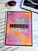 Motivational card with positive affirmations on a wooden surface