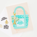Decorative gift tag with 'Happy Birthday' text and Eiffel Tower design on a textured surface.