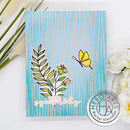 Card with floral design and butterfly on a blue background, surrounded by flowers and grass.