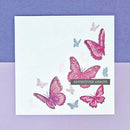 Card with pink and blue butterflies and 'Adventure Awaits' text on a purple and white checkered background