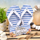 Blue and white striped flip-flop card with 'Happy Birthday' text on a wooden surface with decorative elements.