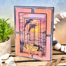 Birthday card with dolphins and 'On Your Birthday' text on a decorative surface with plants and stones.