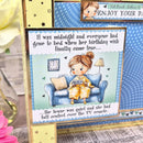 Greeting card with a cartoon character sitting on a couch with a TV remote, surrounded by decorative elements.