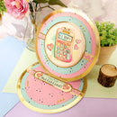 Decorative plates with a calculator design on a table with flowers and plants.