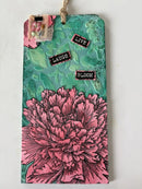 Notebook with pink floral design and motivational stickers on a white background