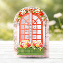 Decorative window frame with flowers on a blurred natural background