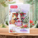 Christmas card with a fairy in front of a snowy house, featuring 'Season's Greetings' and 'With Love' text.