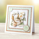 Greeting card with floral design and 'All My Love' text on a wooden surface.