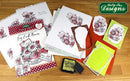 Collection of craft supplies including books and cards on a wooden surface with 'Katy Sue Designs' branding.