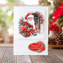 Christmas card with Santa Claus and poinsettias on a wooden surface with festive decorations.