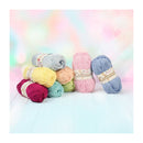 Colorful yarn balls with 'Cotton' label on a soft, multicolored background