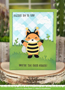 Card with a fox bee design and text on a wooden surface