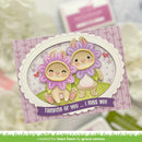 Card with cute animal characters in flower costumes and 'Thinking of you... I miss you' text on a blurred background.