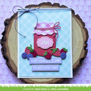 Handmade card with a pink jam jar design on a wooden surface