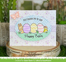 Easter card with colorful eggs and bunny on a decorative stand with plants in the background