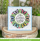 Mother's Day card with colorful butterflies on a wooden block with cacti in the background