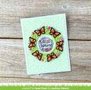 Card with butterfly design and 'Hello Spring' text on a wooden surface