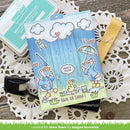 Card with duck illustrations and cloud designs on a wooden surface with crafting tools.