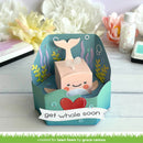 Whale-themed card with 'get whale soon' text on a wooden surface with flowers in the background